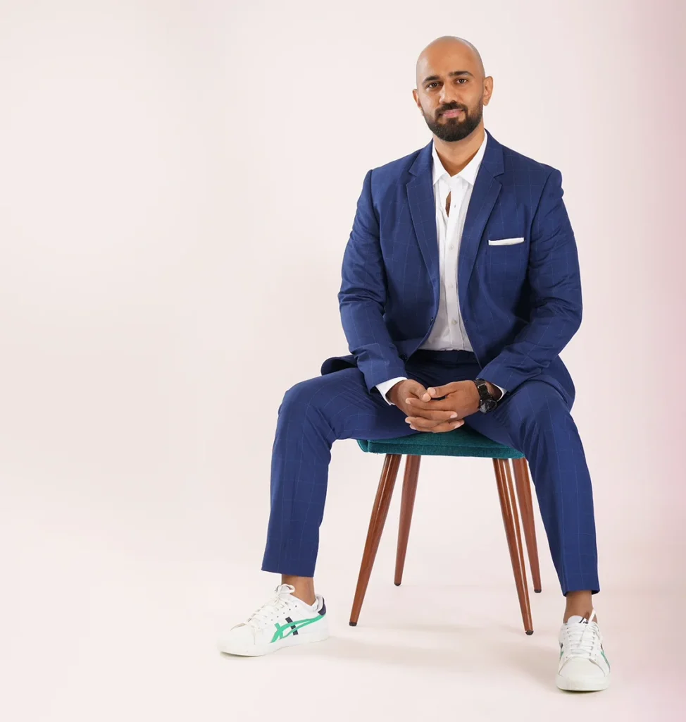 Tony Puthedan seated in a navy suit